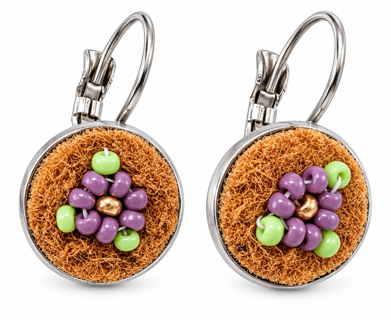 A pair of silver leverback earrings with round brown moose hide facepalm charms featuring purple and bronze beaded flower details, shown on a white background.