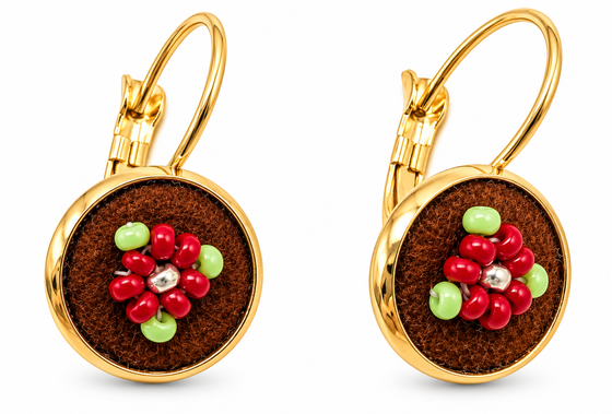 A pair of gold leverback earrings with round brown moose hide facepalm charms featuring red and bgreen beaded flower details, shown on a white background.