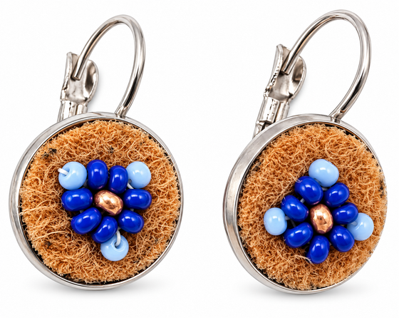 A pair of silver leverback earrings with round brown moose hide facepalm charms featuring blue and bronze beaded flower details, shown on a white background.