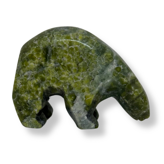 An inquisitive, bright green soapstone bear stands on all fours, head bowed as though examining something on the ground. This bear faces right.