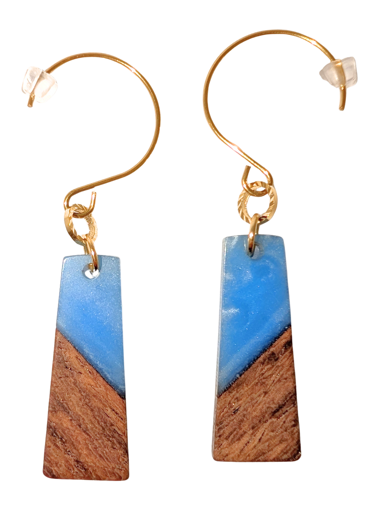 A pair of rectangular hook earrings. The top half is blue and the bottom is walnut wood. Hardware is gold.