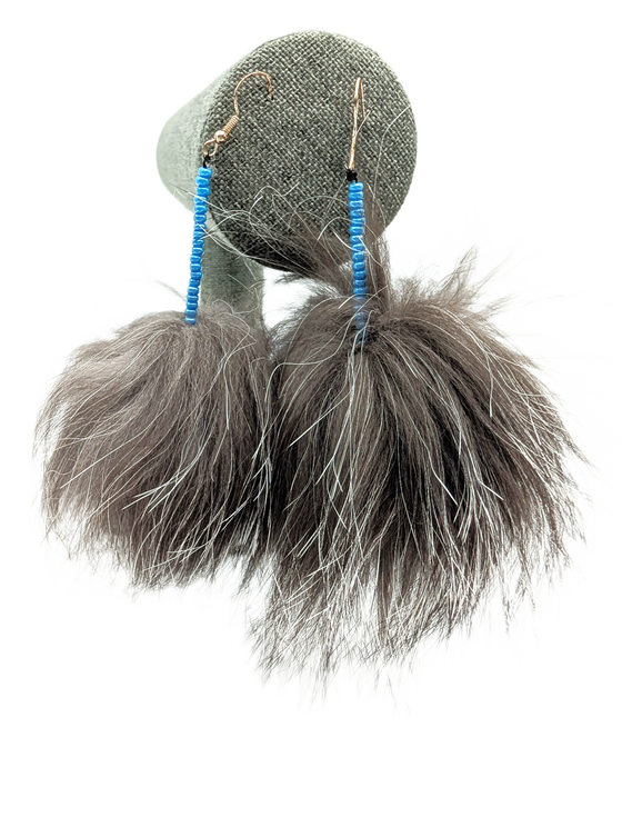 Furry sealskin earrings in the shape of pompoms. Blue bead detailing.