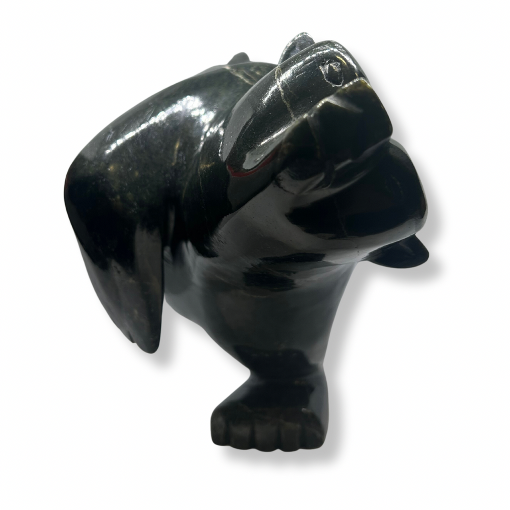 This large bear plunges into the water. The piece is balanced to stand on one forepaw, its other arm raised as though paddling. Its powerful, squarish head strains as though reaching for a fish. This bear faces the viewer.