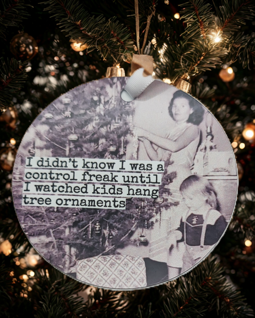 Ornament with a picture of a family decorating a Christmas tree in black and white. Text reads 'I didn't know I was a control freak until I watched kids hang tree ornaments'.