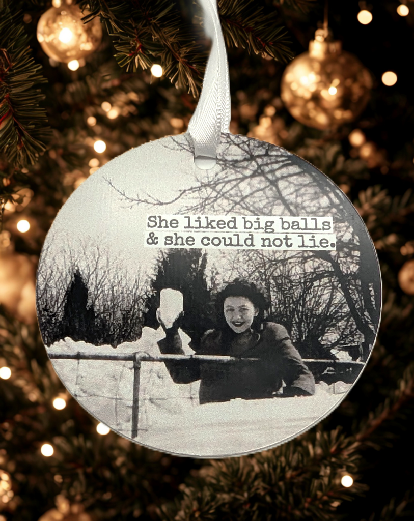 Ornament of a picture of a woman holding a big snowball in black and white. Text reads 'She liked big balls & she could not lie.'