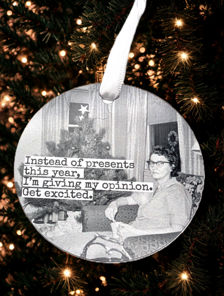 Ornament of a woman sitting by the Christmas tree in black and white Text reads 'Instead of presents this year, I', giving my opinion. Get excited.'