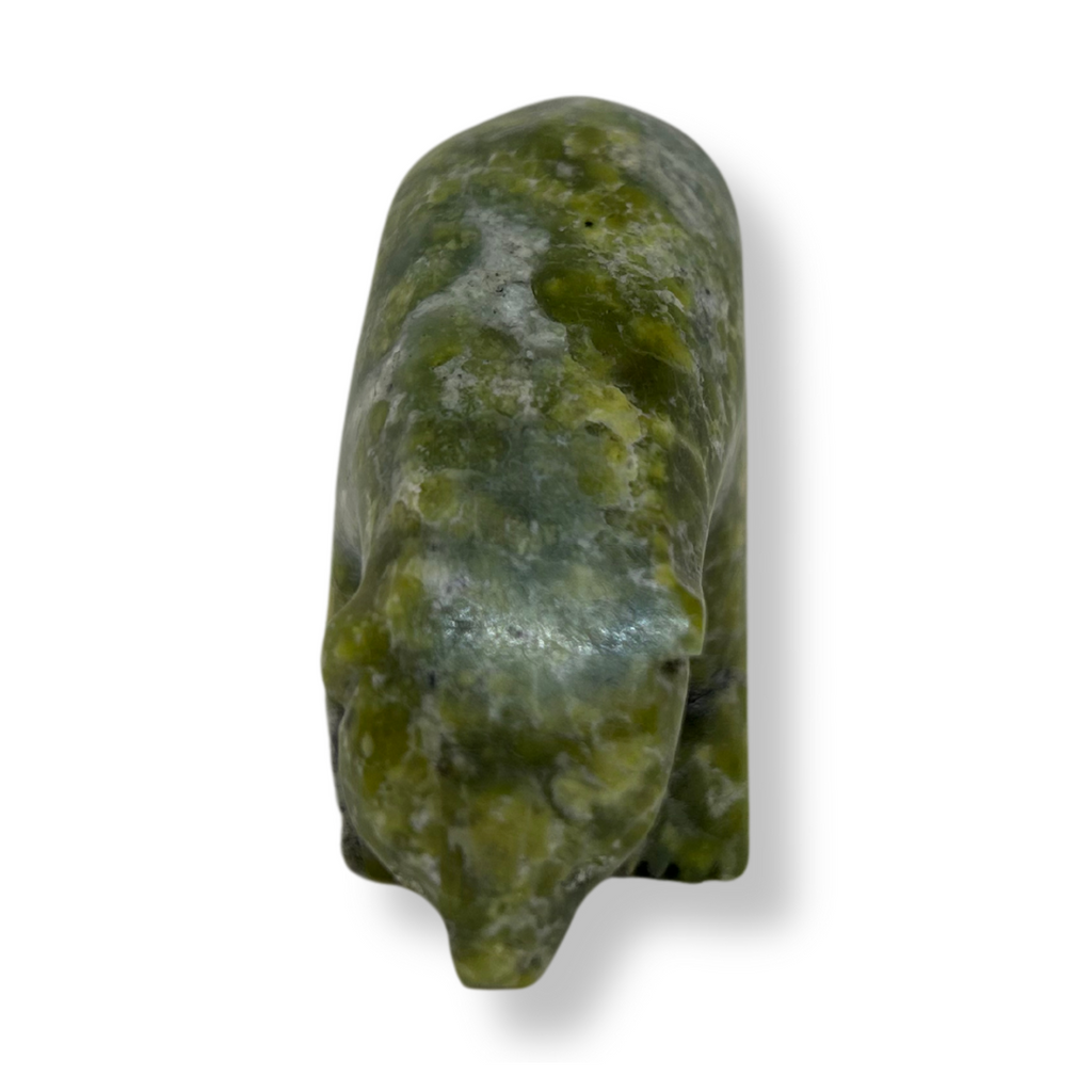 An inquisitive, bright green soapstone bear stands on all fours, head bowed as though examining something on the ground. This bear faces the viewer.