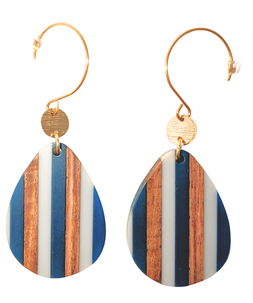 A pair of teardrop hook earrings with a striped white, blue, and walnut wood pattern. Hardware is gold.