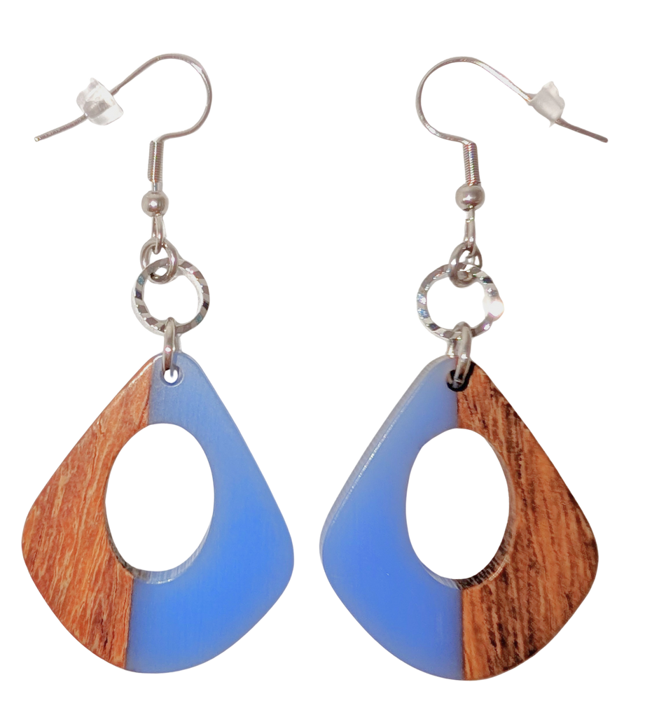 A pair of teardrop hook earrings with a cutout in the middle. One side is blue and the other is walnut wood. Hardware is silver.