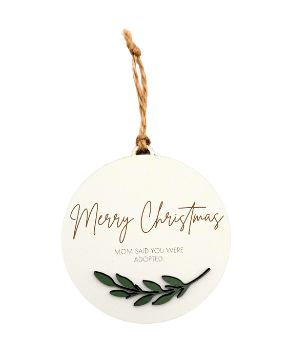 Round Christmas ornament with 'Merry Christmas' and 'Mom said you were adopted' underneath.