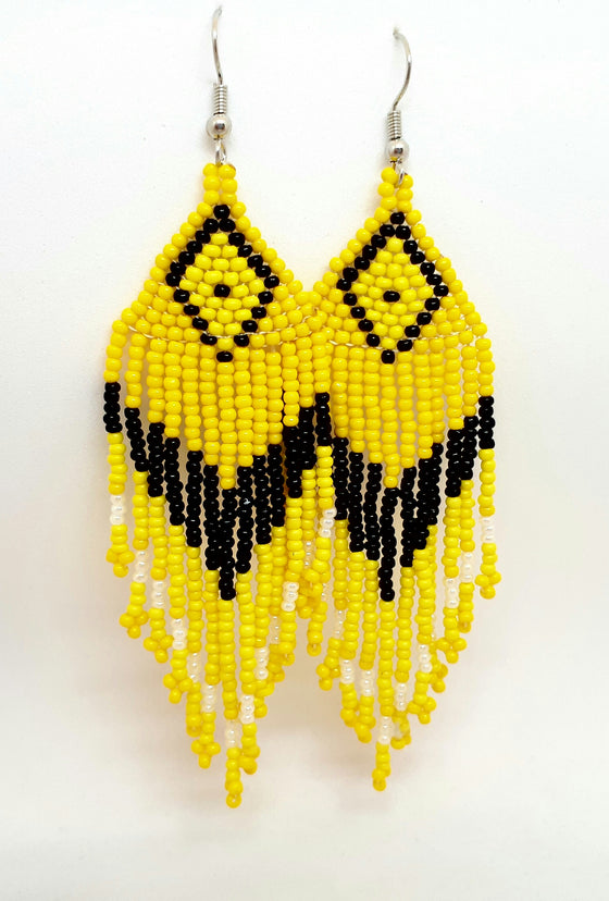 Yellow and black statement beaded earrings handcrafted by Inuk artist Caroline Makimuk. Earrings dangle from silver hook while alternating bead colours create bold indigenous pattern.