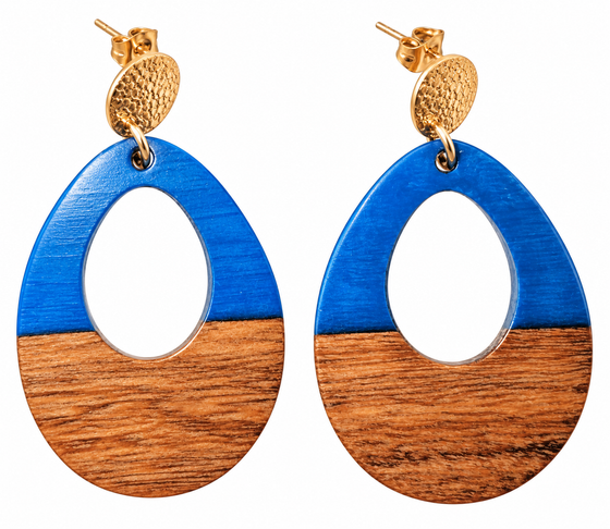 A pair of oval stud drop earrings with a cutout in the middle. The top half is blue and the bottom is walnut wood. Hardware is gold.