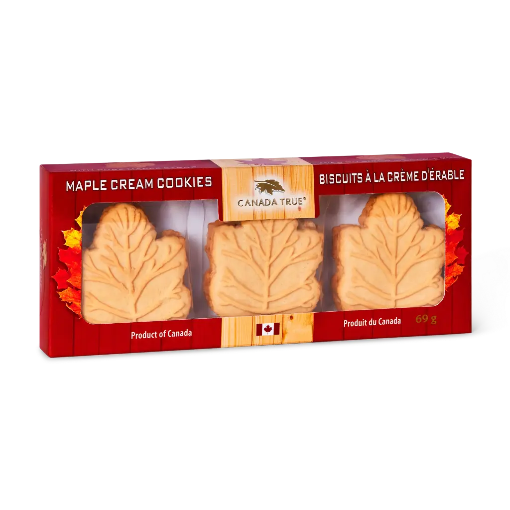 A 69g box of Canada True Maple Cream Cookies, featuring three leaf-shaped cookies visible through a clear window in a red cardboard packaging with autumn leaf designs.