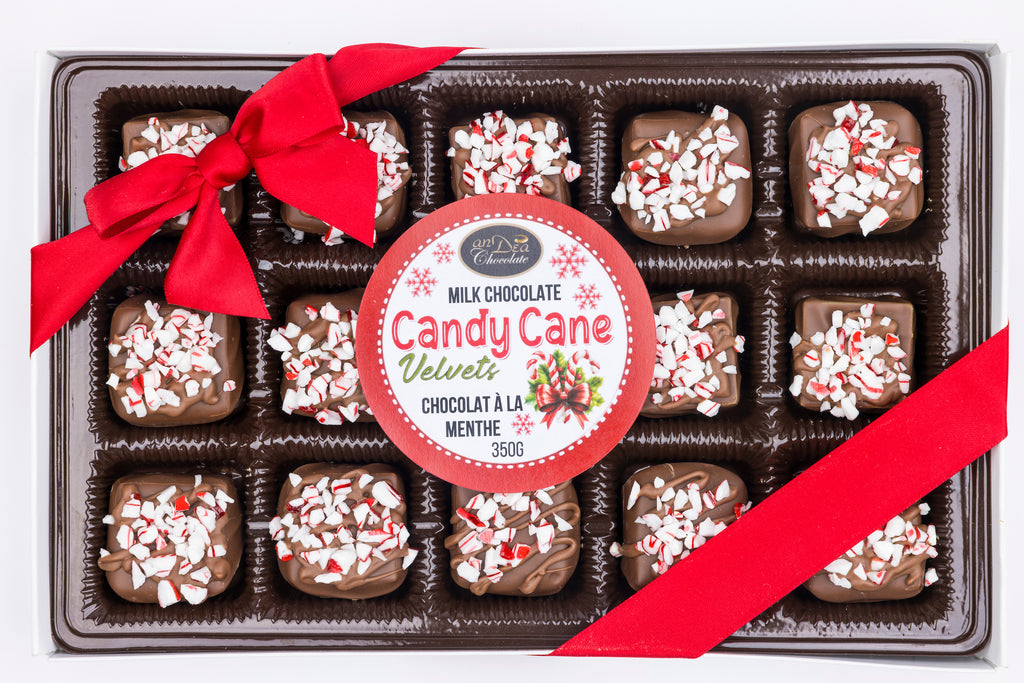 Box of candy cane chocolate truffles with a red ribbon and label.