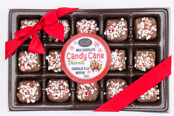 Box of candy cane chocolate truffles with a red ribbon and label.