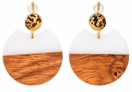 A pair of circular stud drop earrings. The top half is white and the bottom is walnut wood. Hardware is gold.