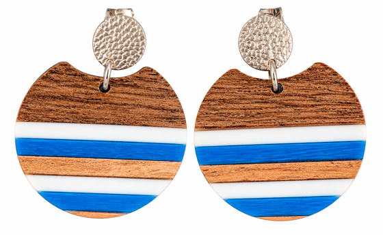 A pair of circular stud drop earrings with a stripes of white, blue, and walnut wood. Hardware is silver.