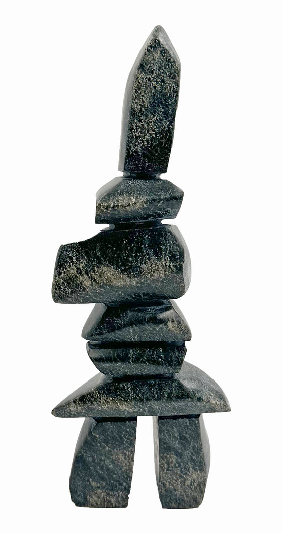 A tall, angular inukshuk made of tapering slabs stacked on top of each other.