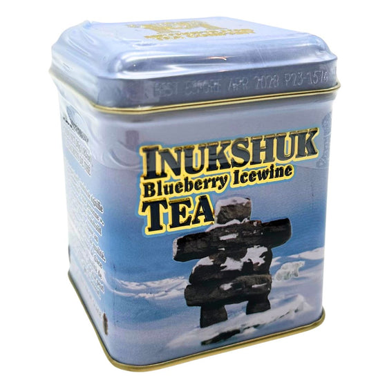 A small blue metal tin that holds twelve blueberry ice wine flavoured tea bags. The artwork on the tin depicts a landscape scene with an Inukshuk and small polar bears. The gold writing on the tin gives a three dimensional element as the words are raised from the flat surface. The lid has a small hinge on one side, allowing the container to be resealed. The tea is blended and packaged in Canada. It includes instructions to brew for three to five minutes, can be served hot or chilled.