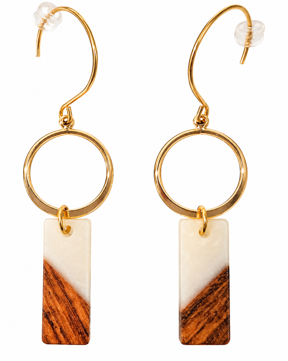 A pair of hook earrings. Earrings have a gold ring and hanging from it is a rectangular bead that is half white and half walnut wood. Hardware is gold.