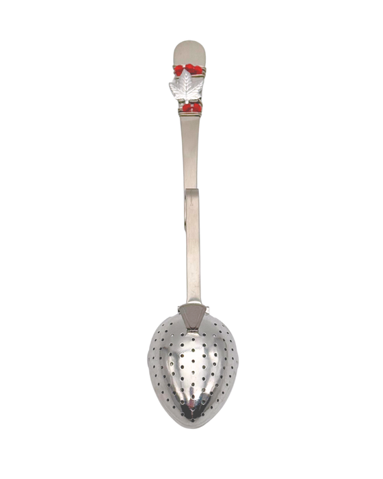 Metallic tea infuser with a small maple leaf and red beads at the top of the handle.