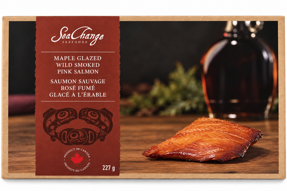 Picture features a single 227g portion of maple smoked salmon contained in a travel pack. On the travel pack, there is a small space alocated for haida art of the Canadian pacific salmon by artist Don Yeomans.