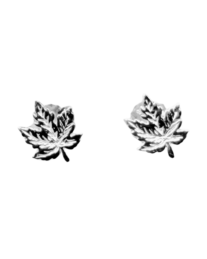 Two small sterling silver maple leaf earrings sit on a black background.  The earring backs cannot be seen.