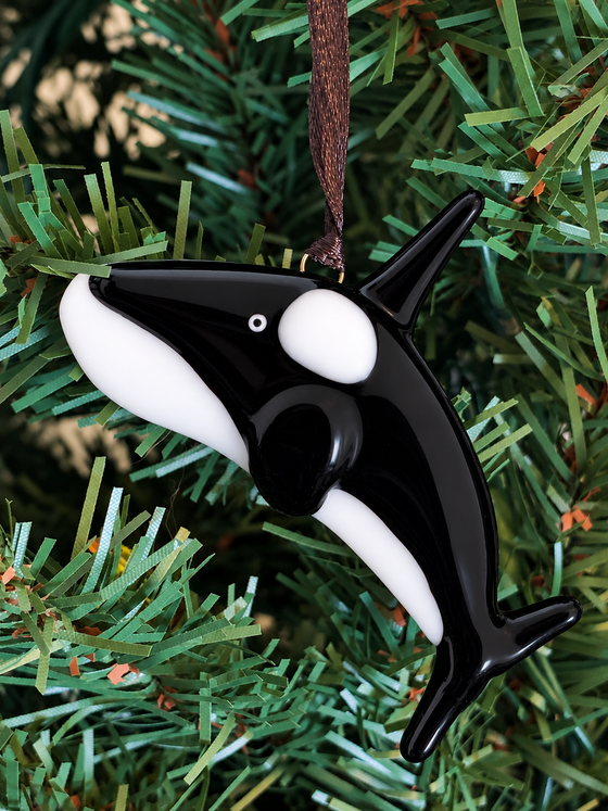 A fused glass orca ornament.