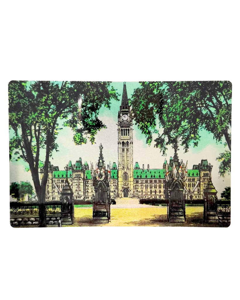 A metal postcard with an image of Parliament.