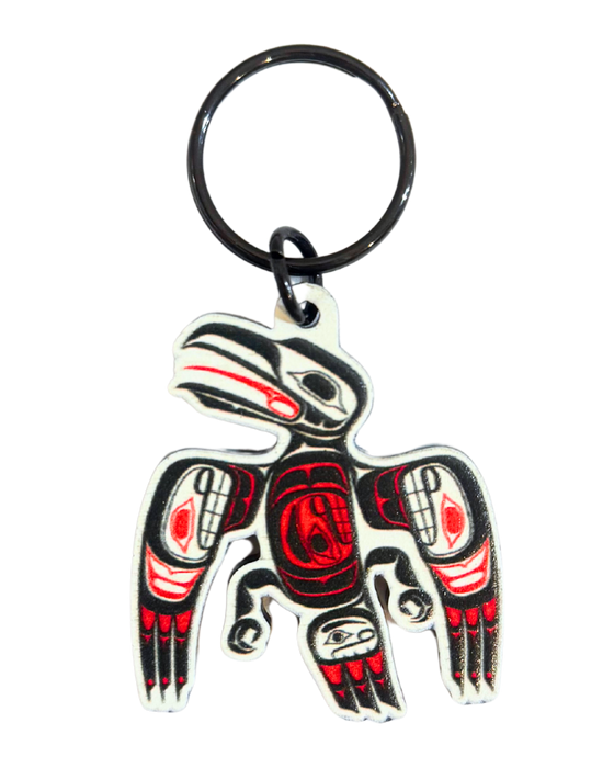Keychain with an indigenous style raven. Colours include White, black, and red.