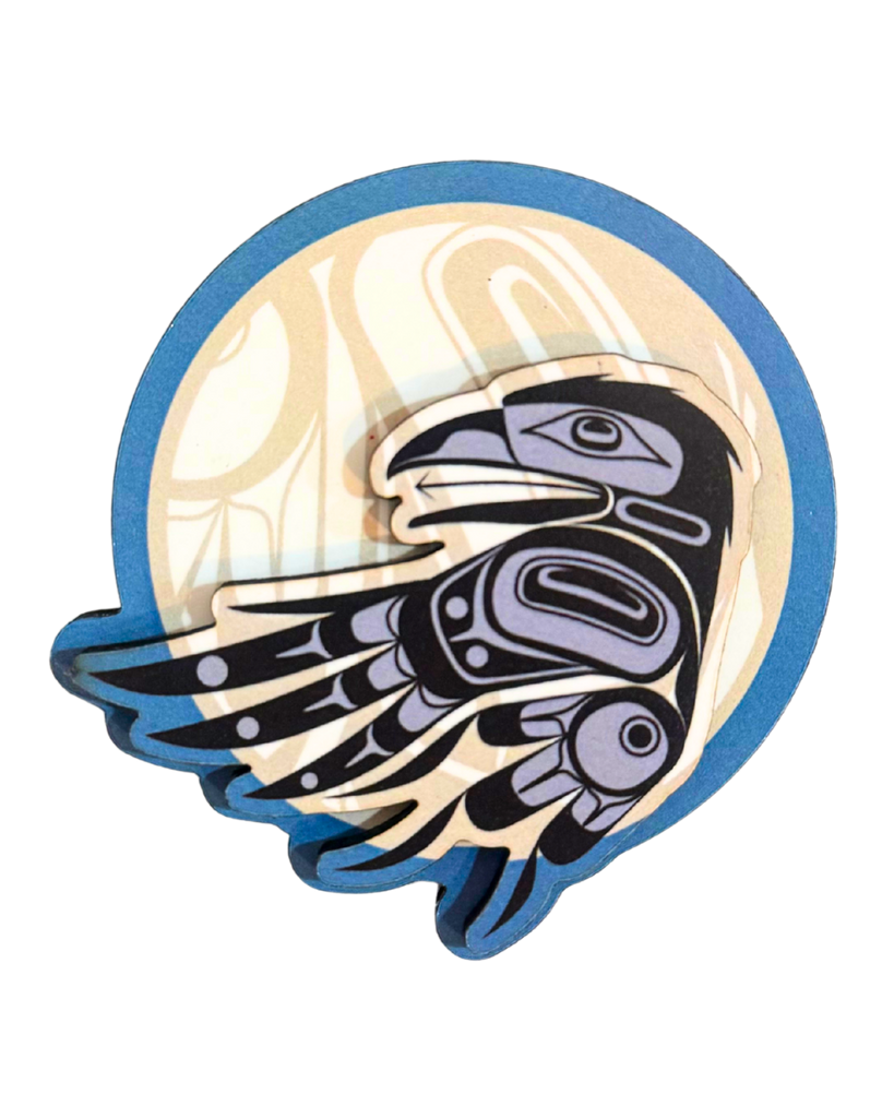 Indigenous style raven infront of moon magnet. Raven is black with greyish blue detailing and the moon is a pale yellow. Has a blue border.