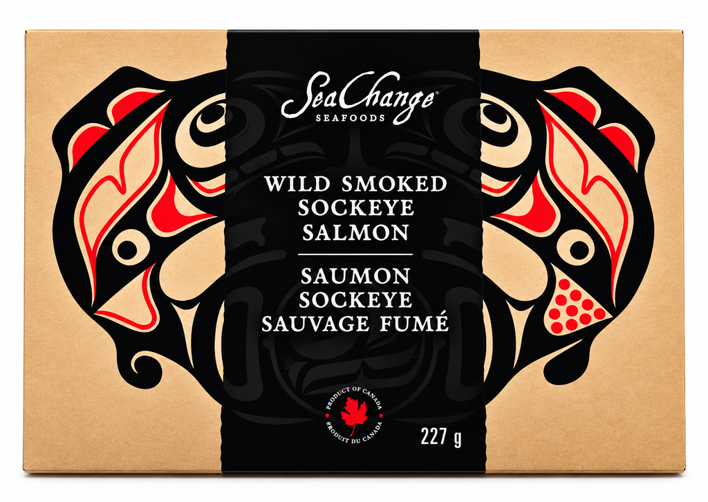 Picture features a single 227g smoked salmon travel pack. On the travel pack, Haida art of the Canadian pacific salmon by artist Don Yeomans is shown.