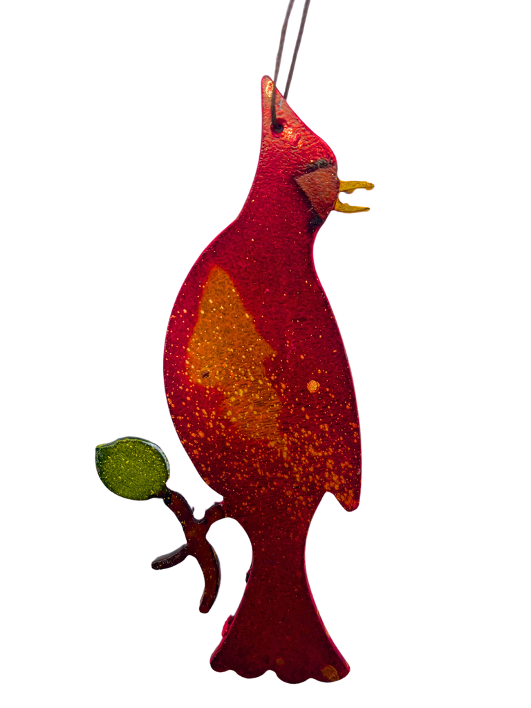 A cawing cardinal sitting on a branch. The cardinal and branch are handpainted with bright and vivid colours.
