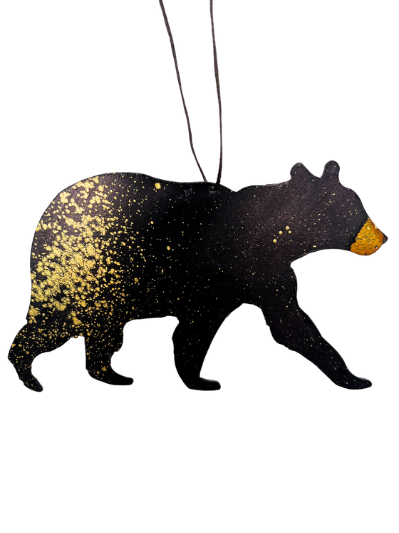 A walking bear, cut from steel and handpainted with striking black and gold.