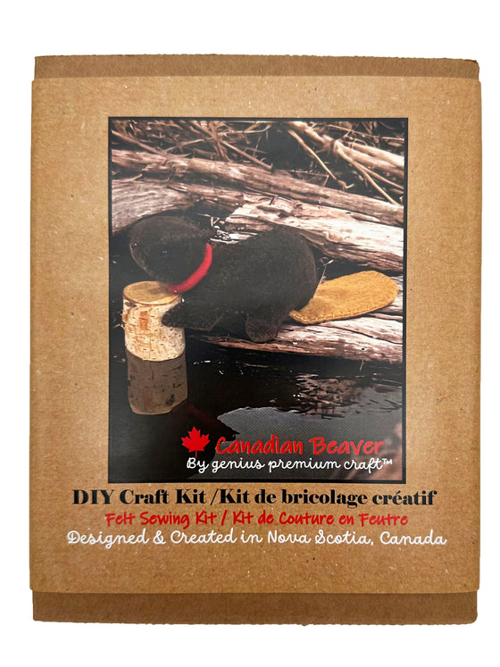 A handmade felted Canadian beaver with bright red collar sits with a decorative log. The body is dark brown and the tail is a complementary lighter brown.