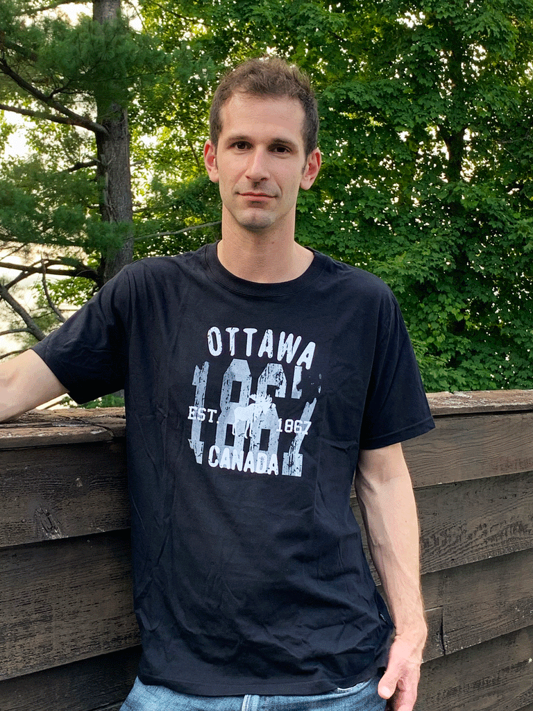 A black shirt. In the middle is "1867". Above is written "Ottawa". Across the year is written "Est. 1867" with a white moose in between. At the bottom is written "Canada".