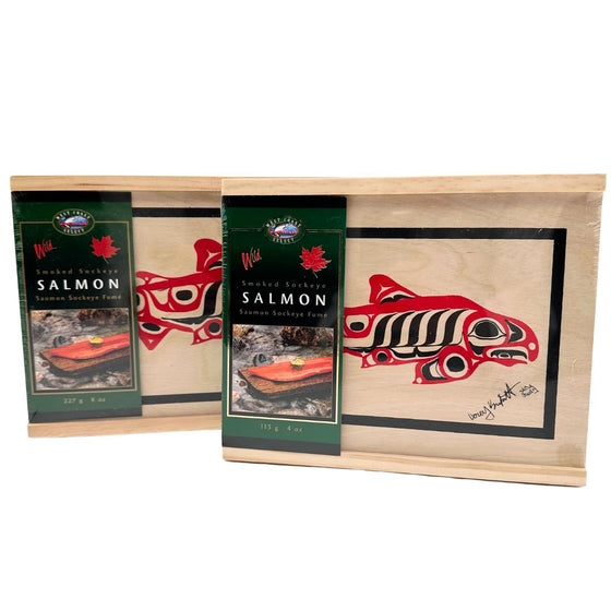 Two boxes of cedar wood salmon. The cover has a design of a salmon and a green slip with a picture of the salmon as well as the brand logo.