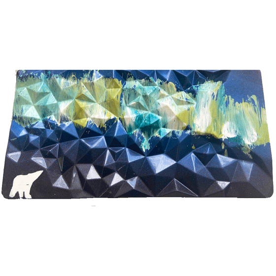 Rectangle chocolate bar with geometric surface. Hand painting of a polar bear and northern light sky. Dark blue sky with light green, yellow, and light blue nothern lights. White polar bear.