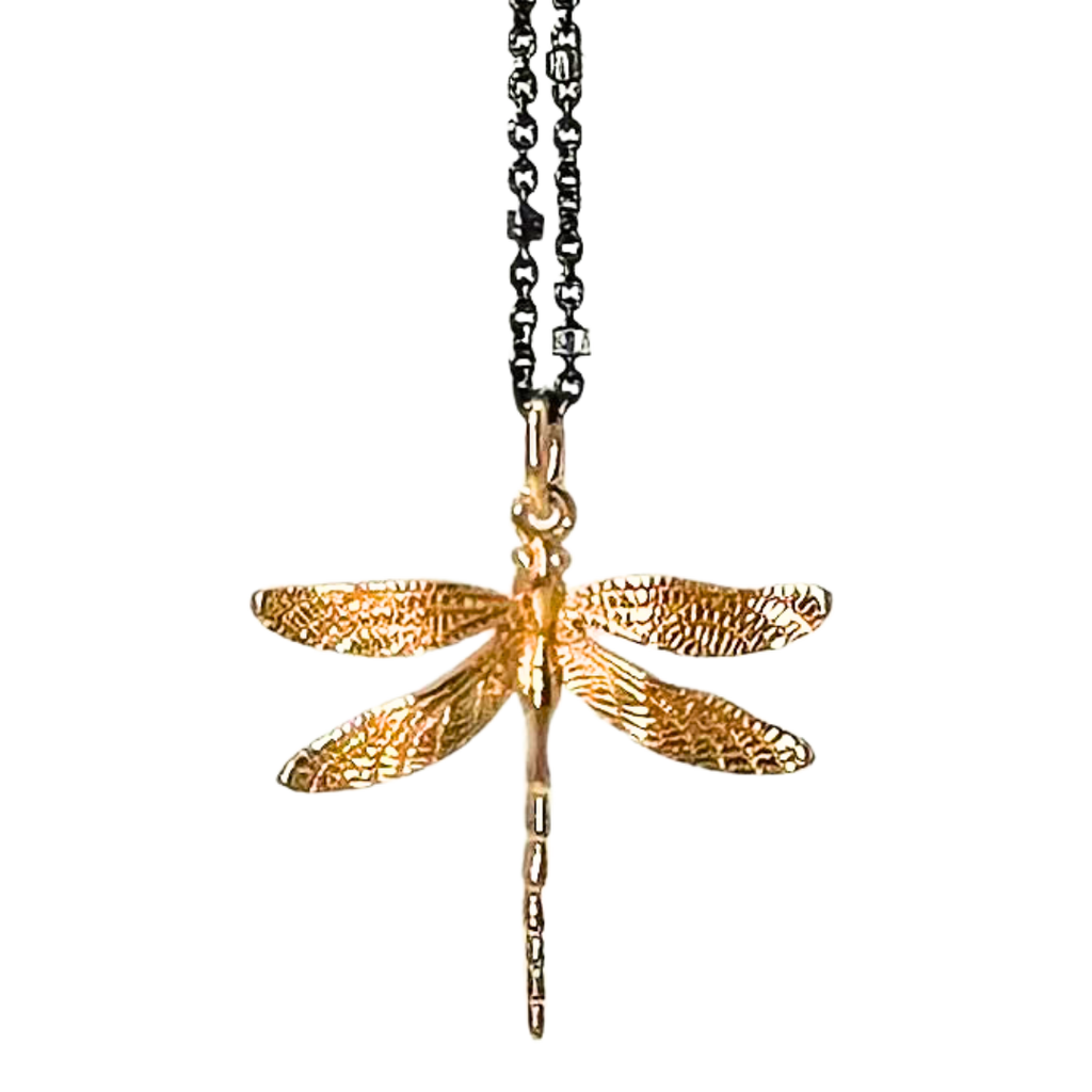 Black chain with thin hexagonal silver rings that are evenly distributed throughout the chain. The pendant is a gold dragonfly with scale detailing on the wings.