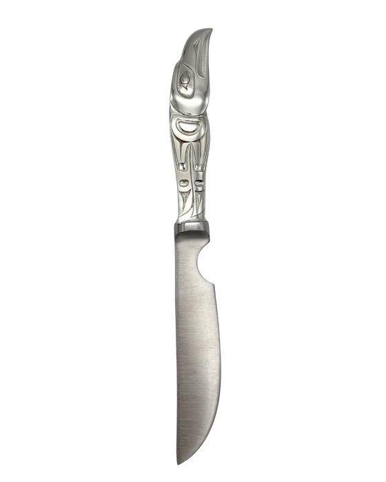 Silver pewter knife with a pointed blade. Handle is detailed with a carved eagle head design.