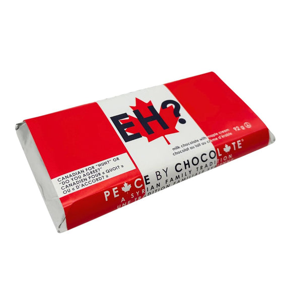 Silver foil wrapped chocolate bar. In a sleeve with a Canadian flag background with black lettering that says "Eh?." Smaller text in bottom left corner says "Canadian for 'huh?' or 'do you agree?'"
