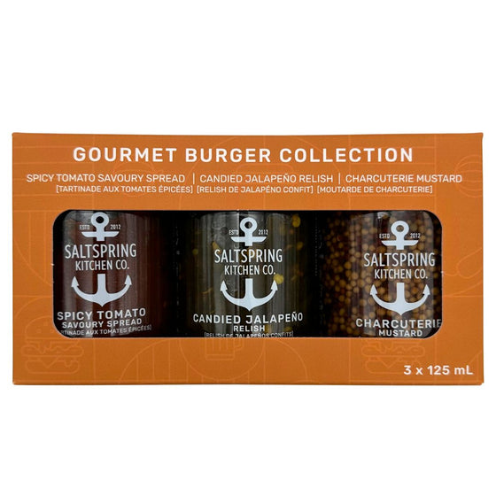 Canadian made pack of three spreads including candied jalapeno relish, spicy tomato ketchup, and whole grain mustard. Clear jars are enclosed in a brown box patterned with black lines and burger outlines.