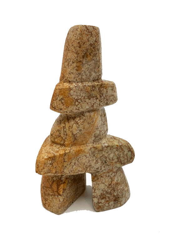 An inukshuk made of four stacked stones on top of two legs. The stone is reddish sand coloured.
