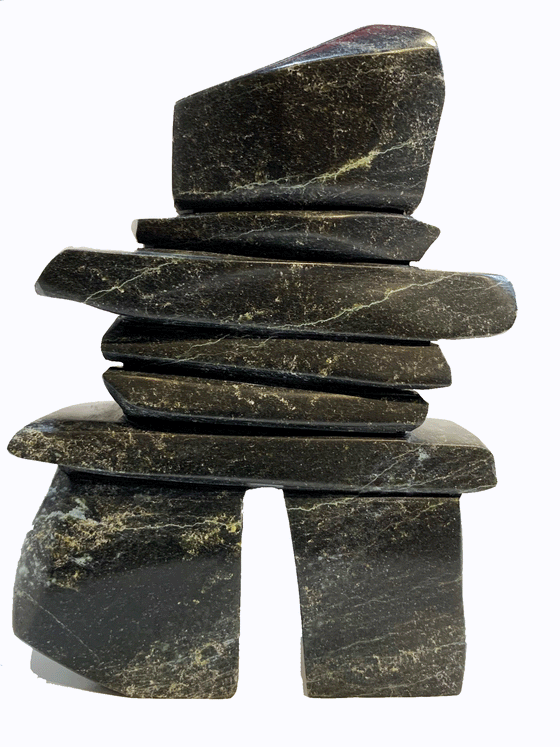 An inukshuk made of five slender slabs stacked on top of two broad legs and topped with a large head. The stone vivid green and black with brilliant striations, reminiscent of the Northern Lights.