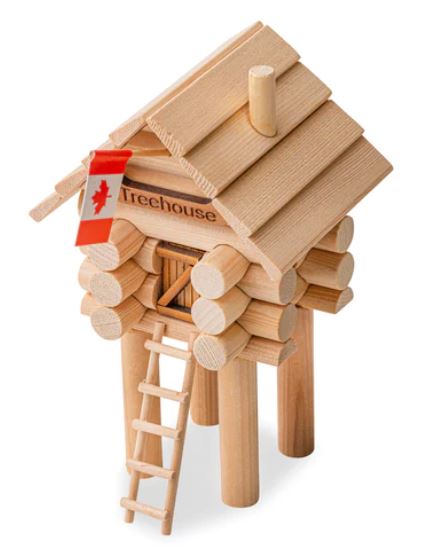 A small treehouse on stilts with a ladder leading up to the traditional Z-panel door. The house is made of interlocked logs and also features a chimney and a Canadian flag above the door.