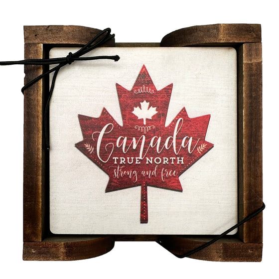 Set of 4 True North Strong and Free Coasters with a red maple leaf in the center against a white background and "Canada True North and Free' written in the middle and comes with a wooden holder