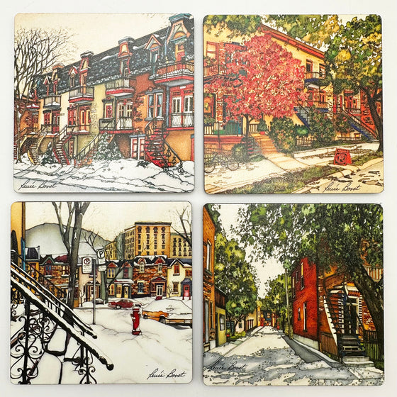 This set of coasters features four unique prints of Montreal across the seasons. One shows the elegant townhouses of Laval street in winter. One shows a row of houses in spring with green trees and a blossoming cherry tree. One shows a street covered thickly with snow, obscuring staircases and parked cars. One shows a wide, sun filled alley in summer. The pictures are richly coloured. The artist’s signature is at the bottom of each coaster.
