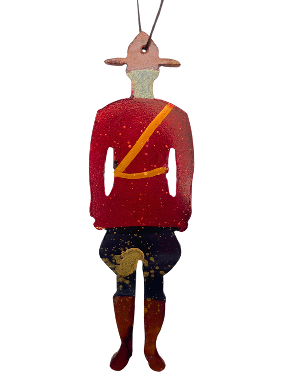 A classic Canadian mountie, cut from steel and handpainted with bold red, black, and gold.