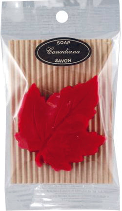 Red Maple leaf shaped soap. Soap is inside a plastic transparent package, with a label reading 'Canadian Soap'.