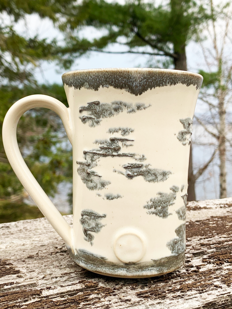 15 oz hand-thrown pottery mug with birch bark glaze and a maple leaf seal.